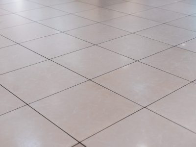 Beige tile on the floor in perspective